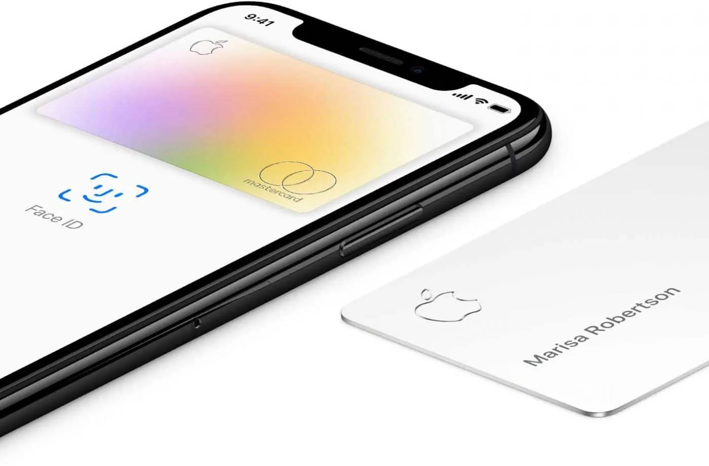 An iPhone showing the multicoloured Apple Card in Wallet next to Face ID, with the physical white titanium card lying beside it.