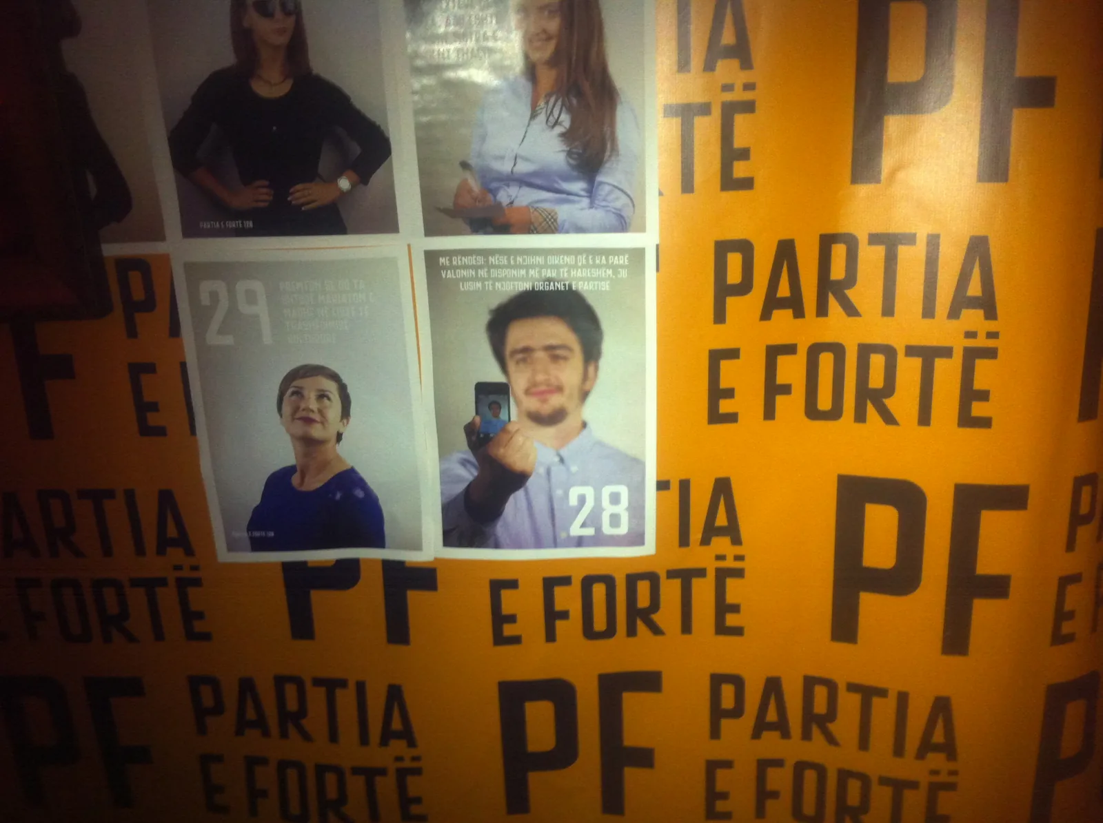 A wall of numbered Partia e Fortë candidate posters, each a young face with a self-deprecating caption.