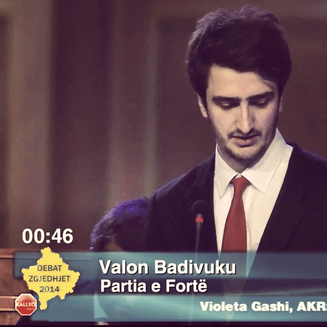 A still from KALLXO's Debat Zgjedhjet 2014 broadcast, showing me at the podium in a suit and red tie with the lower third reading "Valon Badivuku, Partia e Fortë".