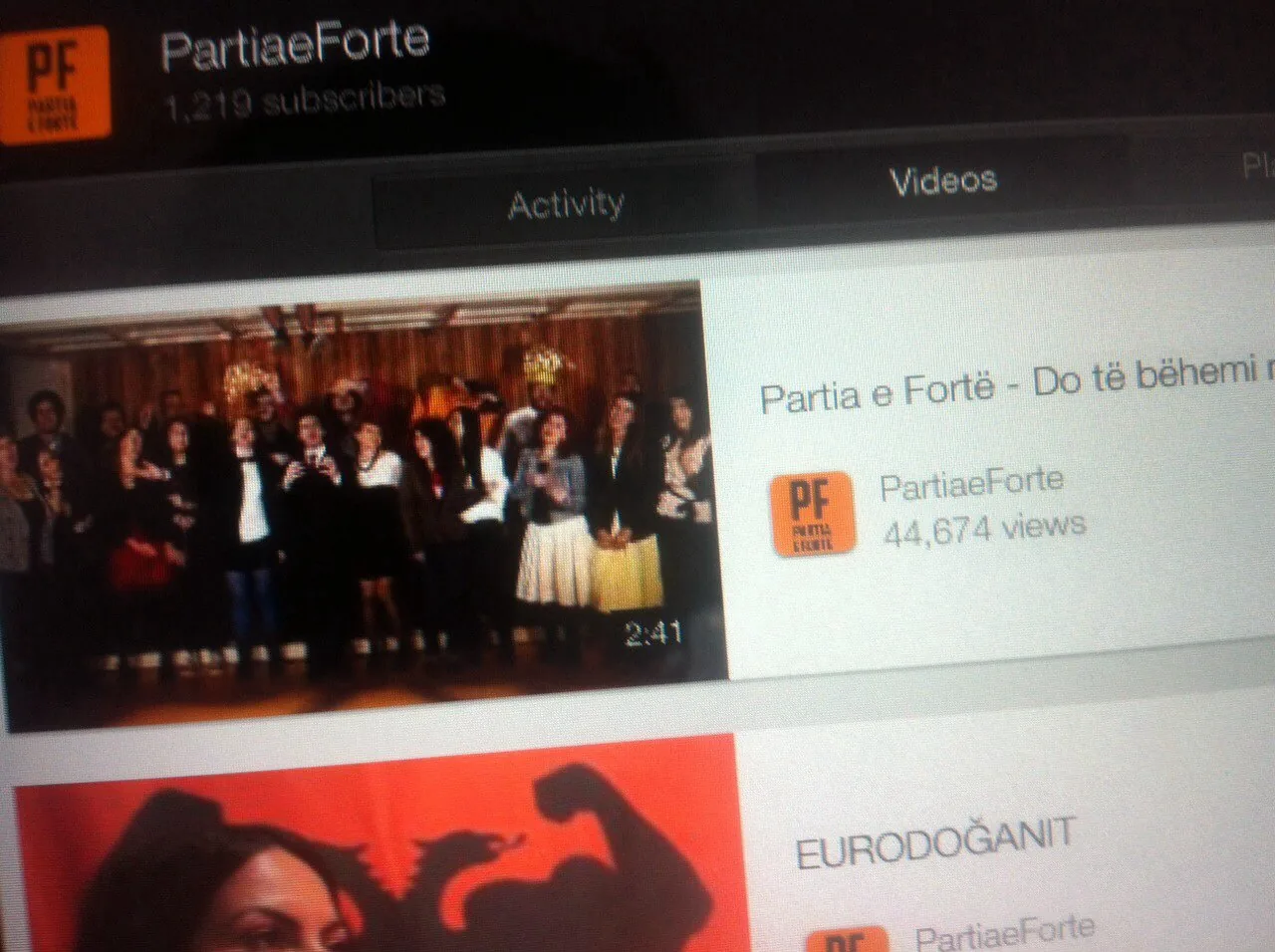 The Partia e Fortë YouTube channel showing 1,219 subscribers and the campaign song at 44,674 views.